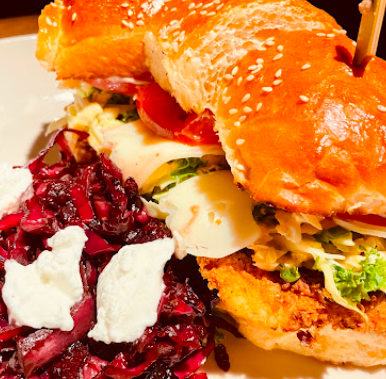 Cherry Creek Grill signature dishes Emerald Kale And Rotisserie Chicken
Ding’s Crispy Chicken Sandwich
Wood-Grilled Ribeye